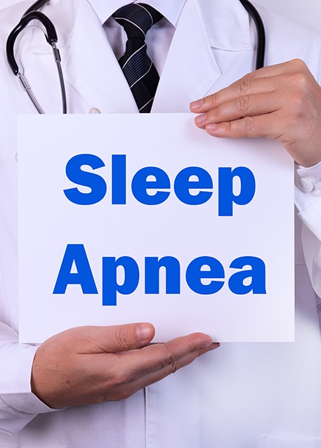 Doctor holding sign that says, sleep apnea