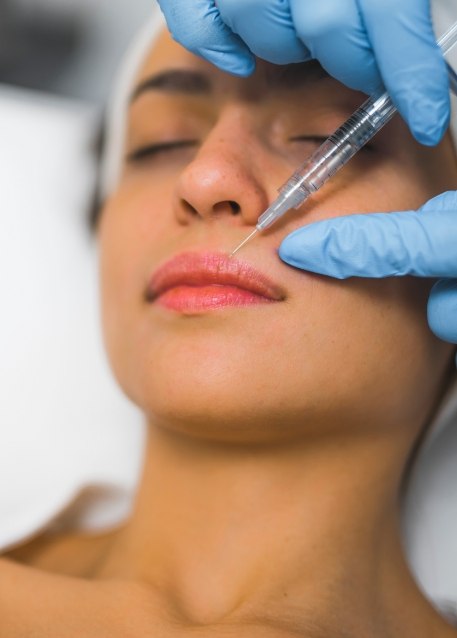 Person receiving Botox injection near their lip