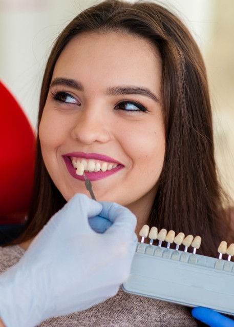 Young woman being fitted for veneers by cosmetic dentist