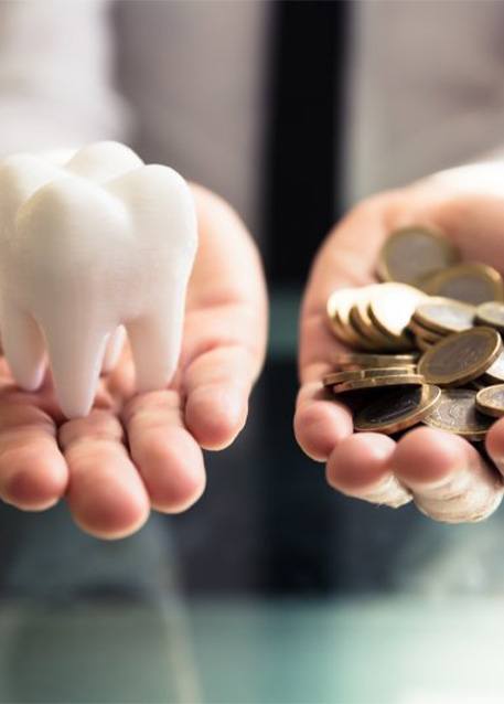 Tooth next to a pile of money