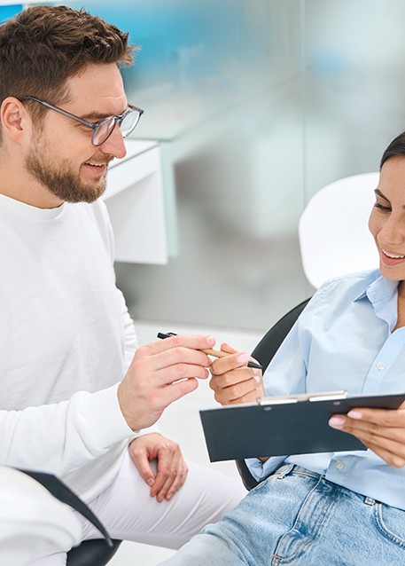 A woman consulting her dentist about treatment costs