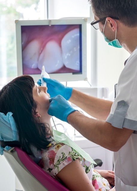 Dentist taking photos of a patients teeth using intraoral camera