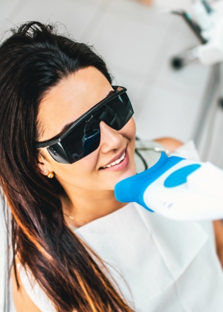 Woman in dental chair receiving professional teeth whitening in Tampa