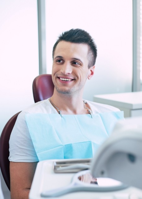 Man in dental chair listening to his dentist
